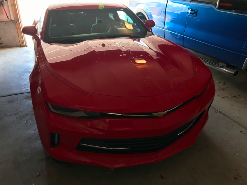 At some point we moved it into the garage. The Camaro is so low that its roof nearly slipped under the tennis ball set to the height of the hood of my friend’s Edge.